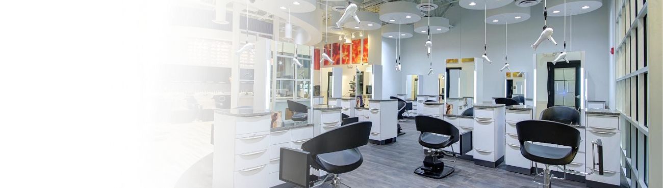 The Town and Country salon floor with white stations and black chairs